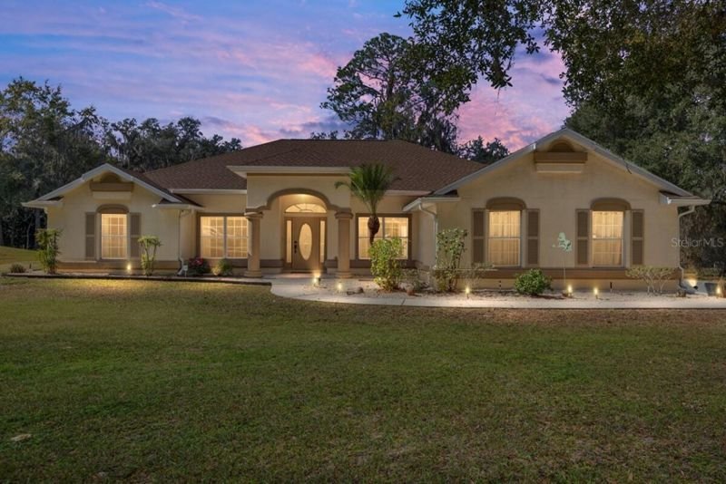 Front elevation at twilight, lit windows