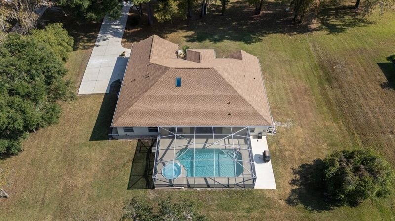 Aerial straight down: pool cage + house