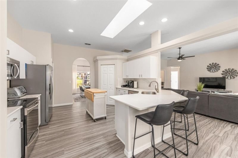 Renovated kitchen with island and stainless appliances