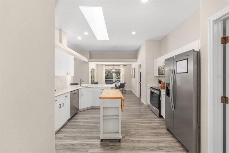 Kitchen, stainless fridge, rolling island
