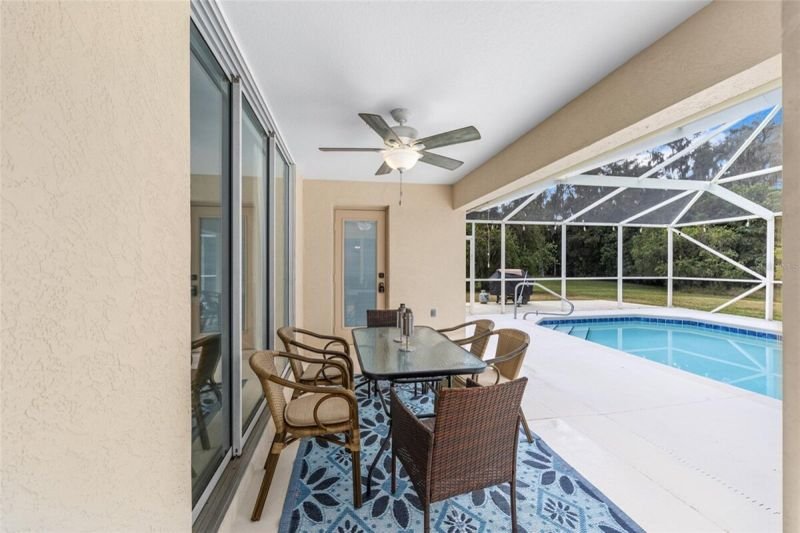 Lanai dining table beside the pool